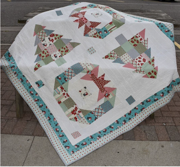 Lisa Jo Girodat Looking for a layer cake or charm pack friendly quilt pattern? Check out EQ user, Lisa Jo's quilt, Trees & Wreaths! Get the free pattern on the Moda Fabrics website! 