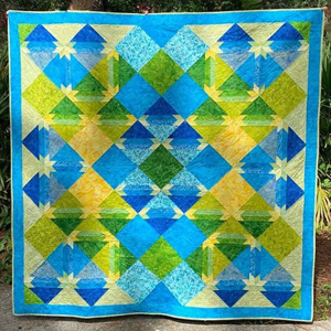 Brianna Roberts Everyone is loving this beautiful quilt by EQ8 user, Brianna Roberts. She used a Kathy Brett Engle fabric line called Free To Fly. The fabric will be out this fall. Brianna says, “I designed this pattern to provide a pop of colors of blues, greens and yellows.“ We love it! See more of Brianna's work on her Instagram page, @briannaroberts71